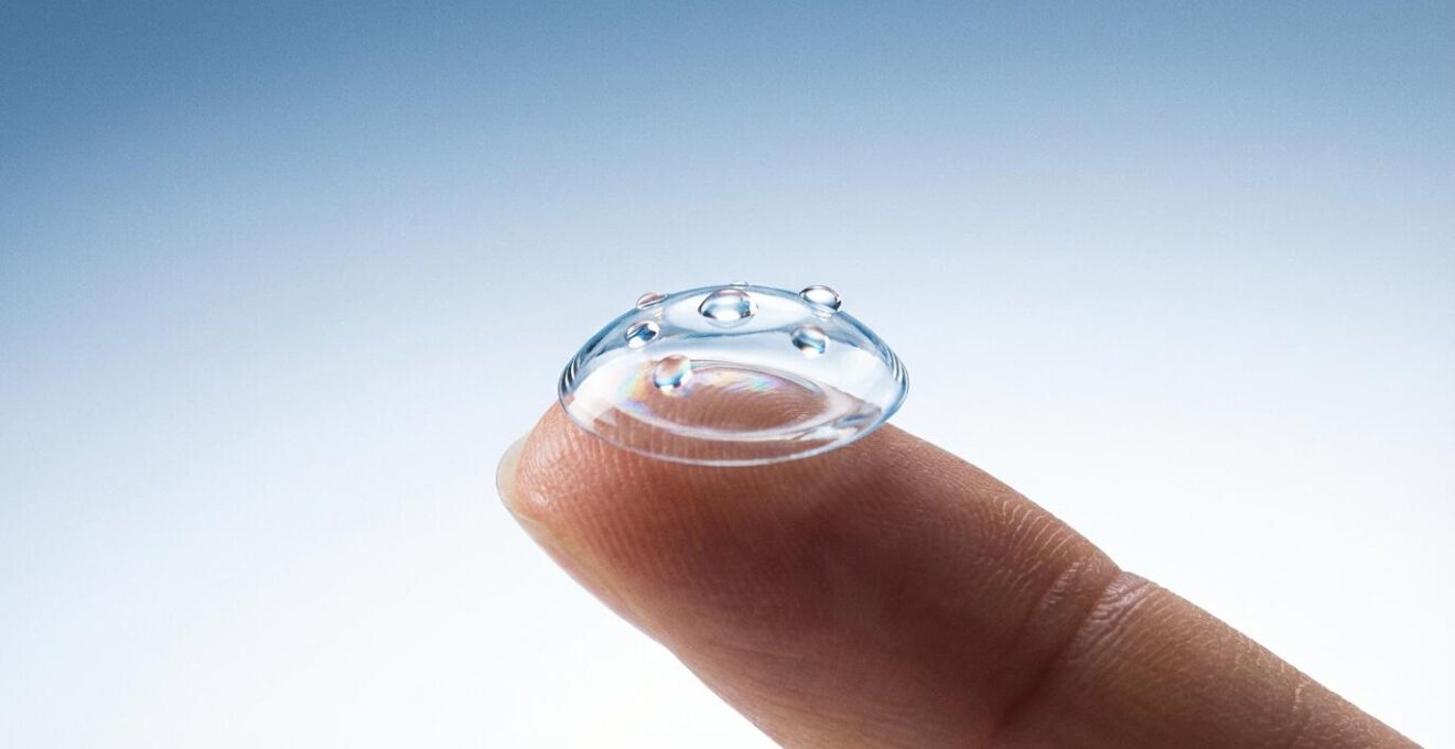 Detailed macro shot of contact lens on fingertip with clean hands demonstration
